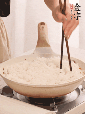 把瀝干水分的米飯均勻鋪在上面，筷子戳幾個洞，以便透氣，轉小火蓋上蓋子燜至水分收干，大概10分鐘。